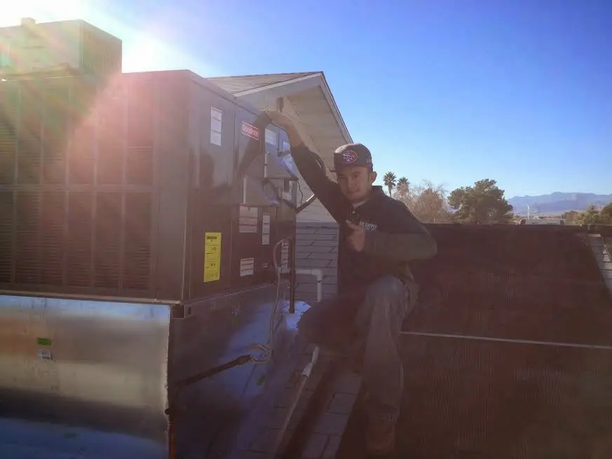 HVAC technician performing Air Duct Repair on a rooftop unit in Lake Morton-Berrydale